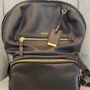 TUMI leather voyageur backpack with gold hardware